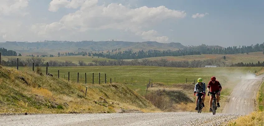 Cyclists ride on a gravel road near Chadron